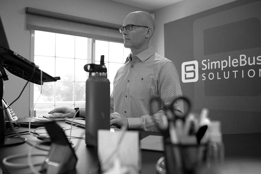 Fractional CMO Tim Rayl working at his standing desk in the office.